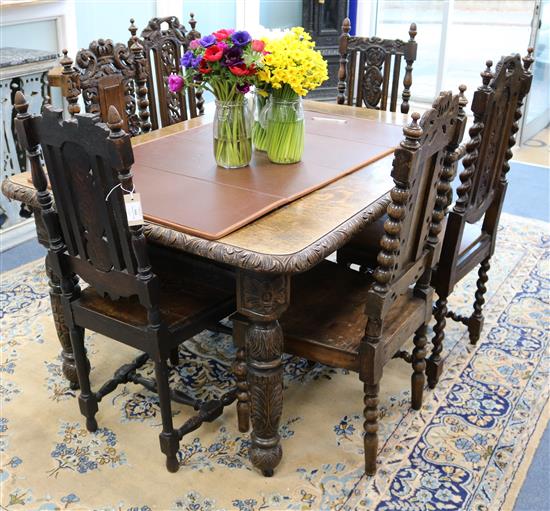 A Flemish carved oak dining table and six Harlequin chairs W.147cm